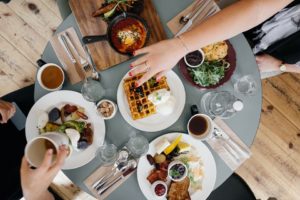 The view of the op of a table filled with coffee and breakfast foods. 