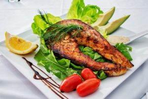 Grilled fish on a bed of lettuce.