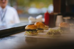 Burgers sitting on a counter.