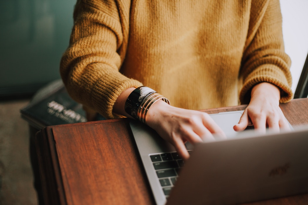 A woman typing on her laptop.