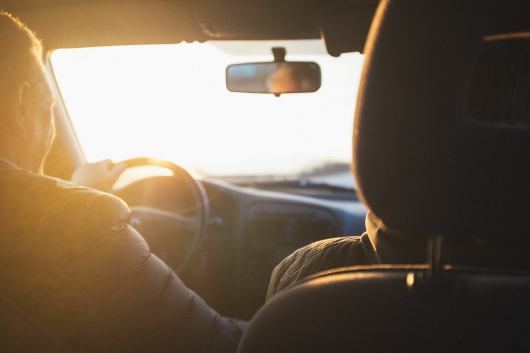 Two people driving in a car.