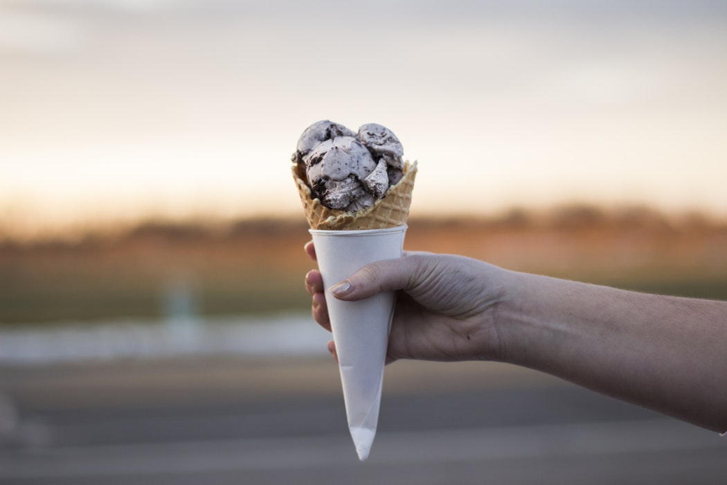 A person holding an ice cream cone.