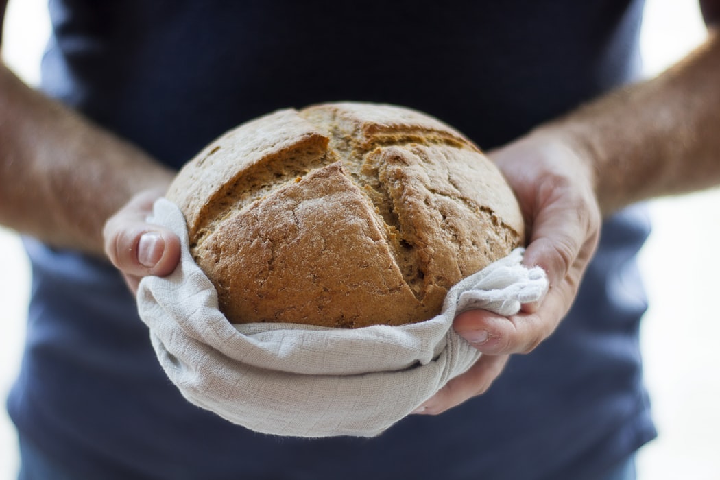 A man holding bread.