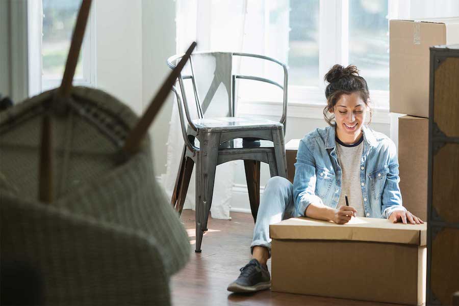 A woman packing boxes.