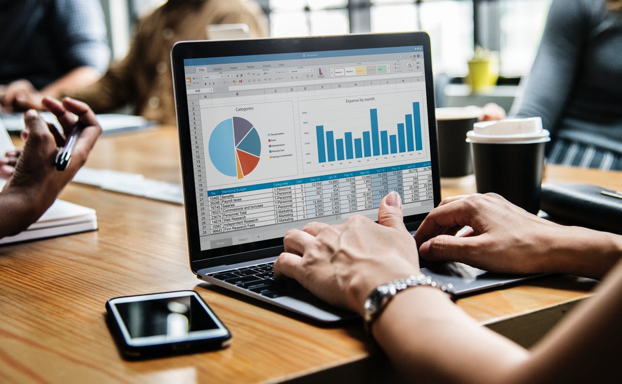 Graphs and data on a laptop screen.