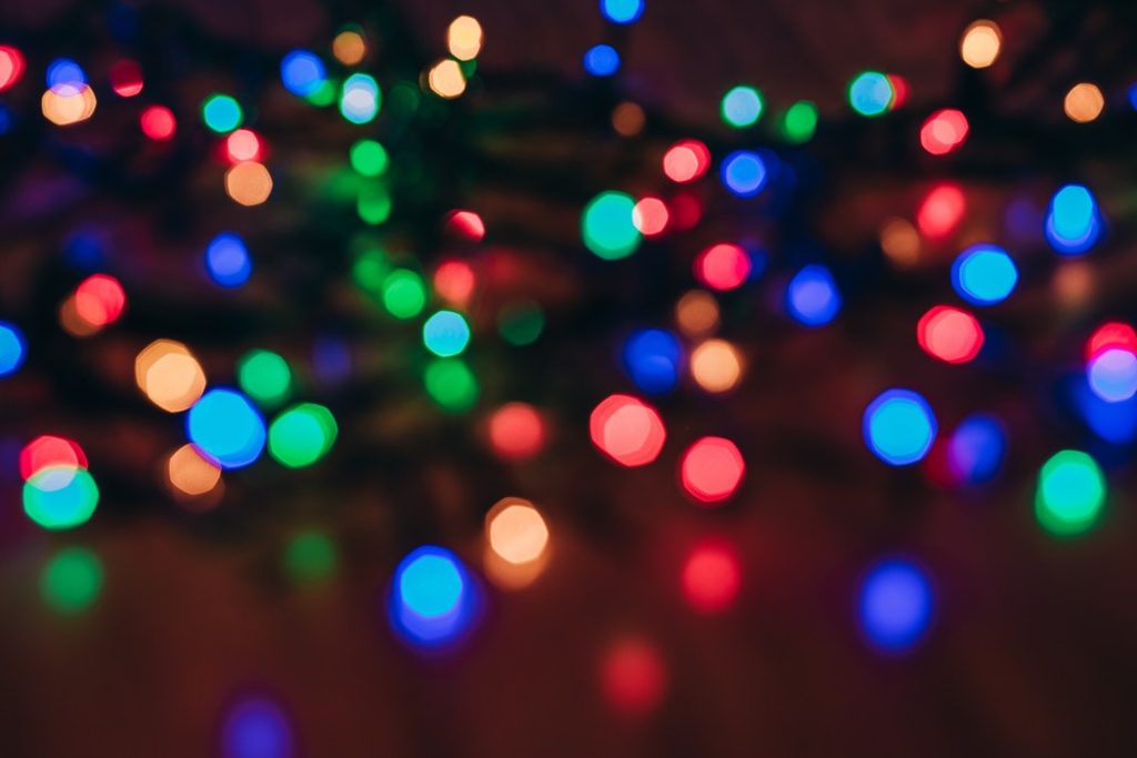 Multicolored holiday lights out of focus. 