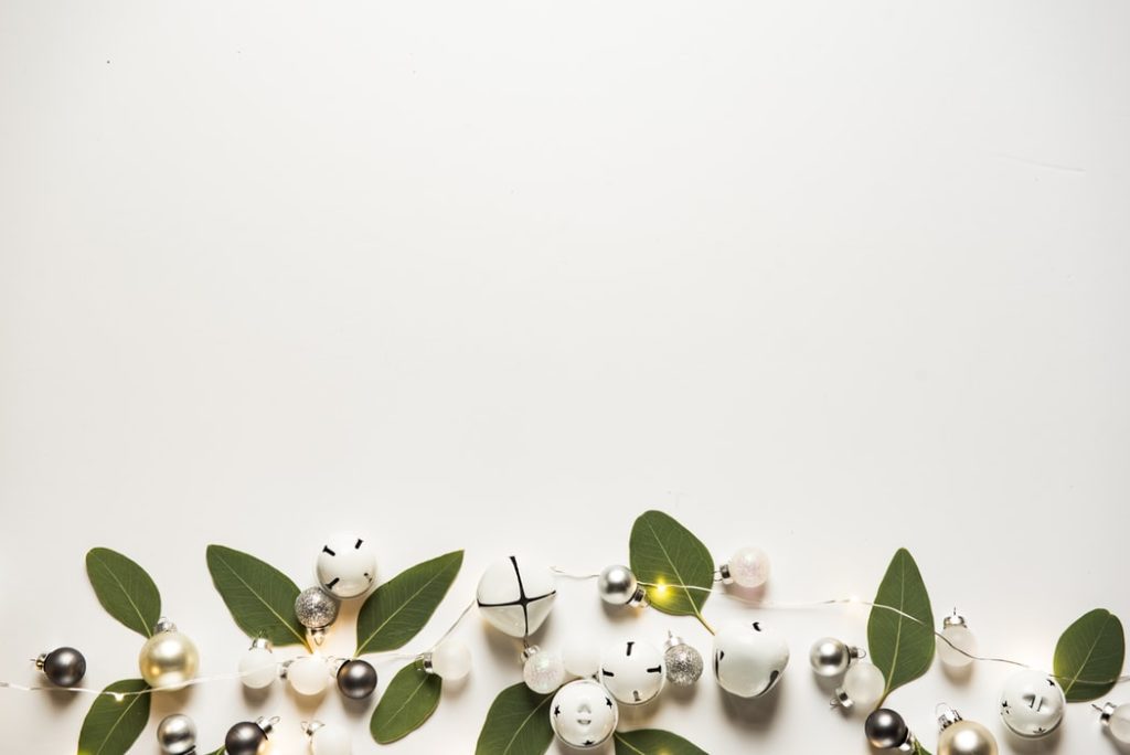 White bells, greenery, and lights that reflect a neutral home staging.