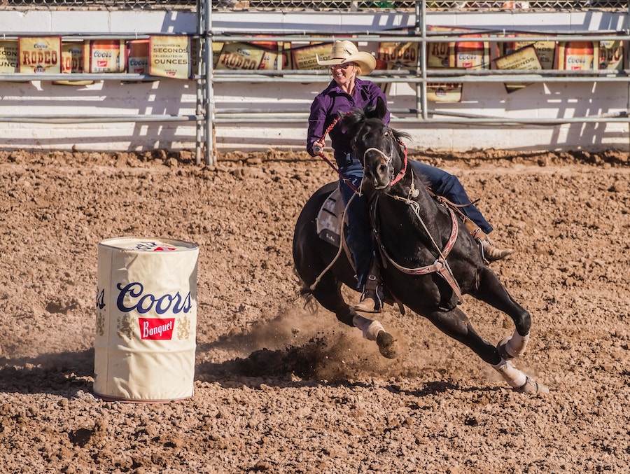 Woman barrel racing on a horse